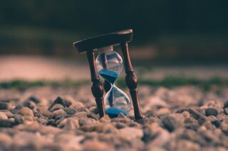 an hourglass with blue sand